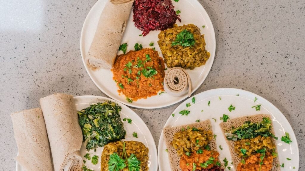 Three plates of balanced meals on a kitchen counter