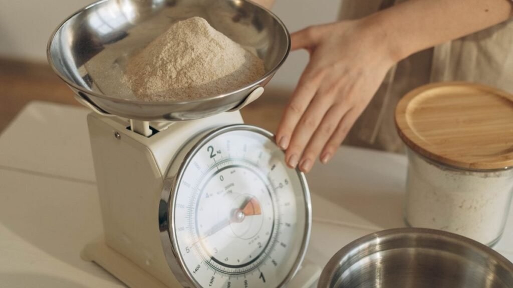 Woman weighing food on a kitchen scale