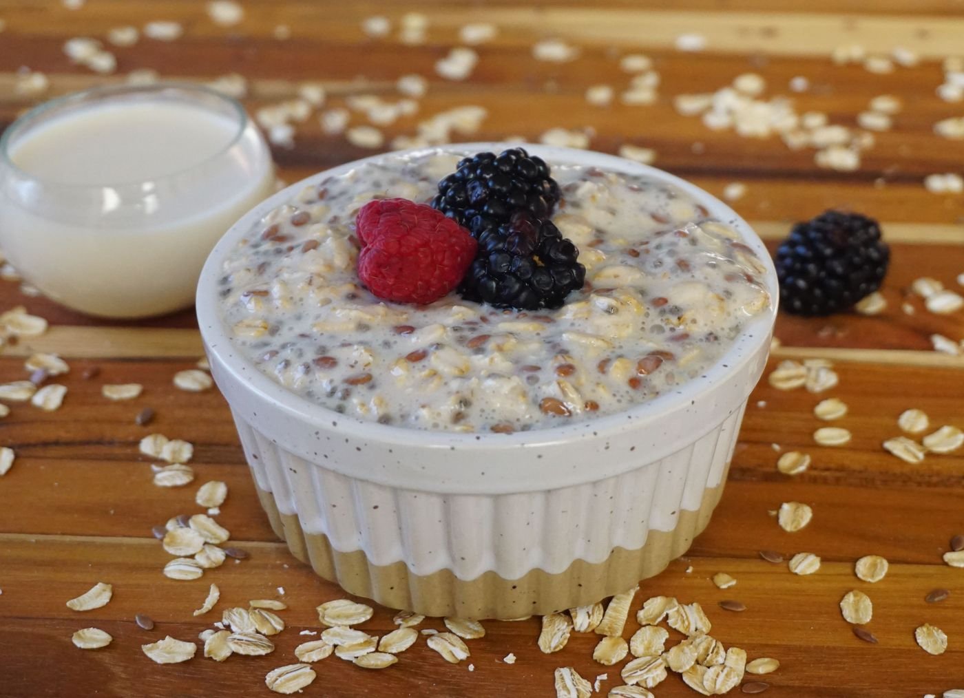 Overnight oats in a bowl topped with fresh blackberries and raspberries